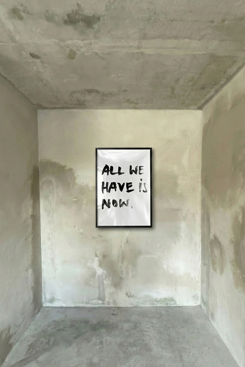 Minimal black brushstroke typography poster on a white background reading “All We Have Is Now,” representing urgency, action, ambition, and a relentless hustle mindset.
