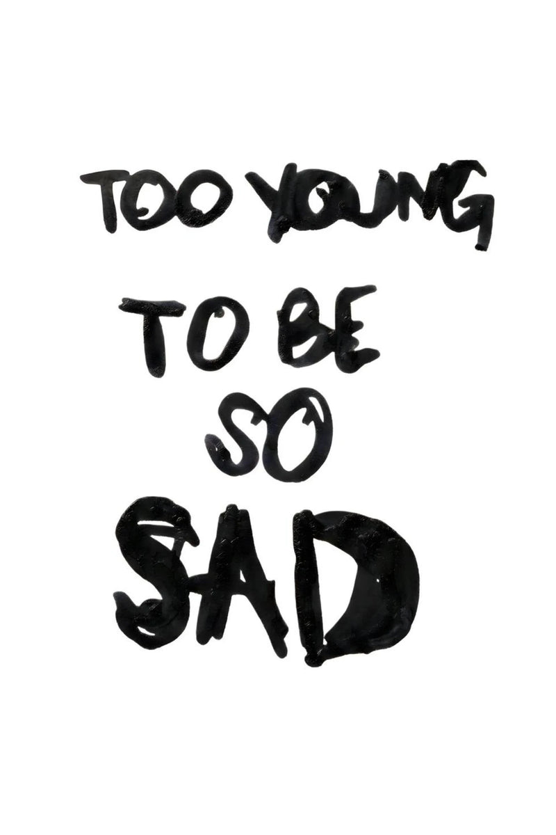 Minimal white poster with bold black brushstroke text reading “Too Young To Be So Sad,” expressing resilience, ambition, and a hustle mindset that pushes past doubt, stays focused, and keeps moving toward success.