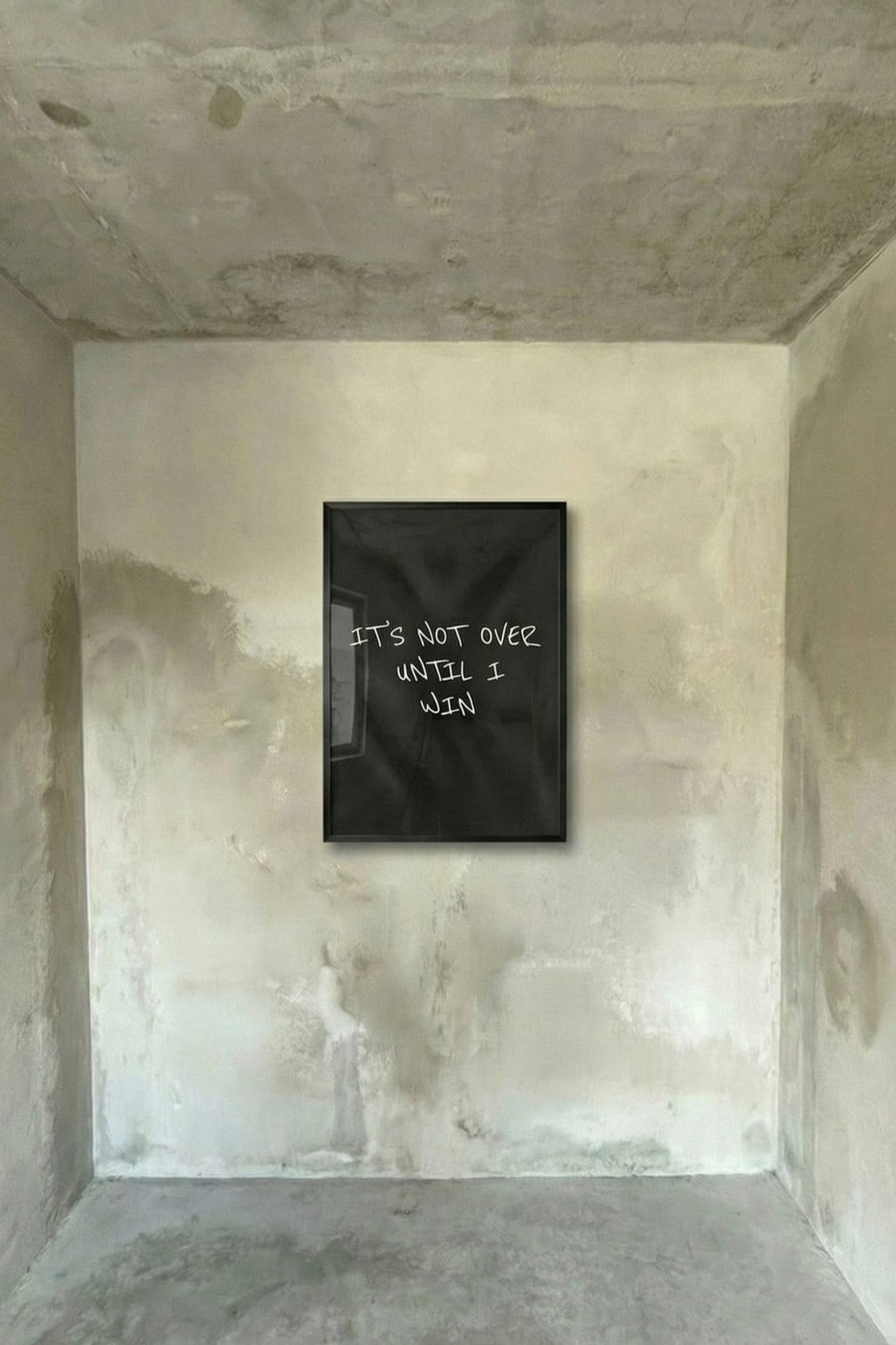 Framed motivational poster with black background and white handwritten-style quote.